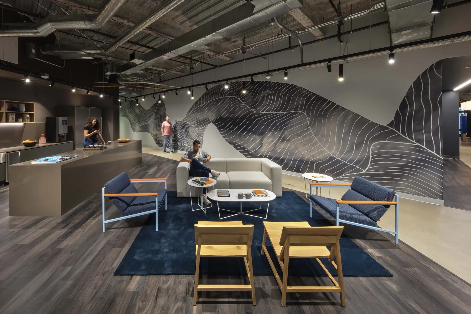 A lounge with a topographic mural at the VF Corporation Denver offices