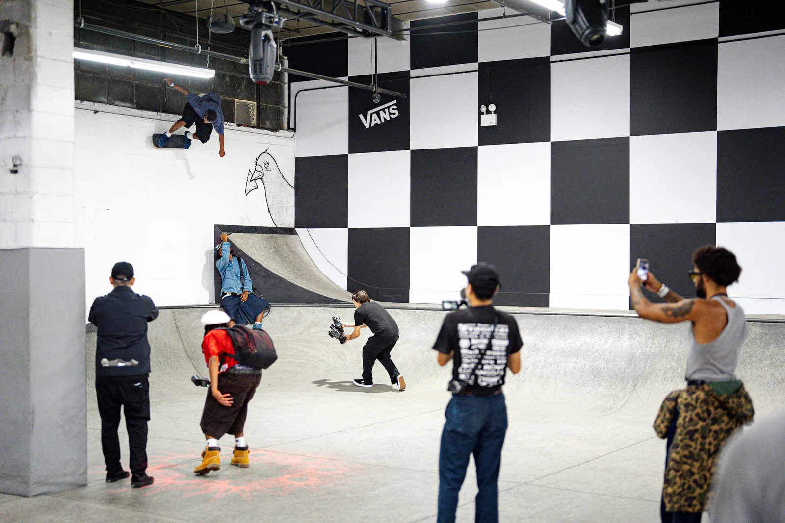 A skater riding the wall at a Vans skatepark event