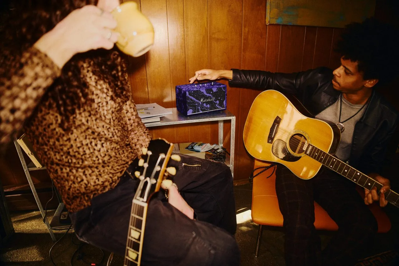 Musicians around a Marshall Acton III speaker