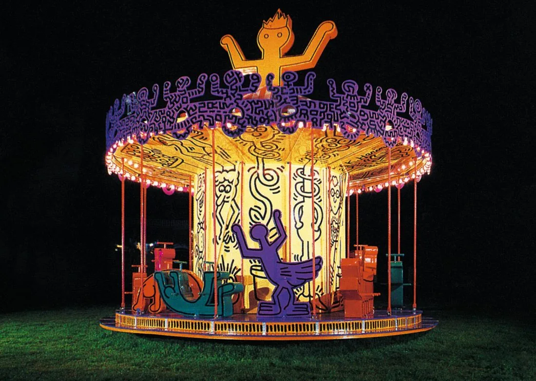 The Luna Luna carousel by Keith Haring, lit at night